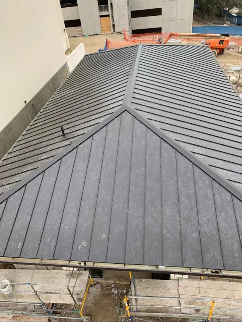 Commercial metal roof construction with crane equipment in Coatesville