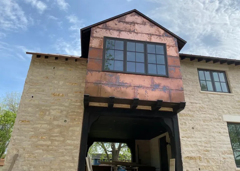 Copper metal panel facade on a stone building for Roof Repair in Coatesville